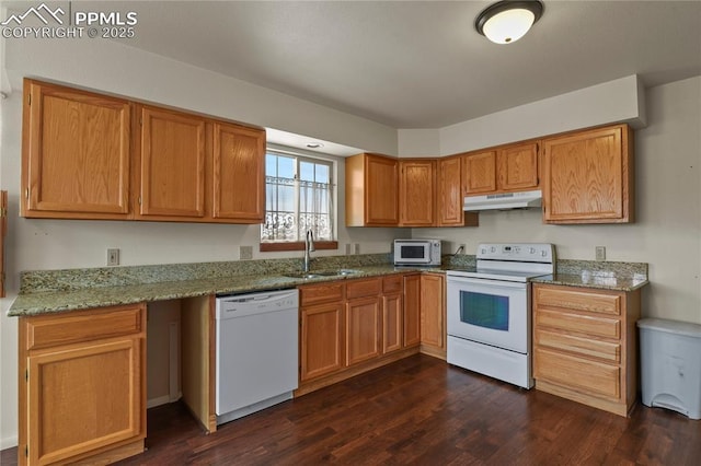 kitchen with white appliances, dark hardwood / wood-style flooring, light stone countertops, and sink