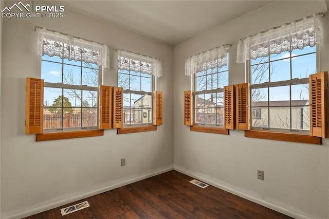spare room featuring dark hardwood / wood-style flooring