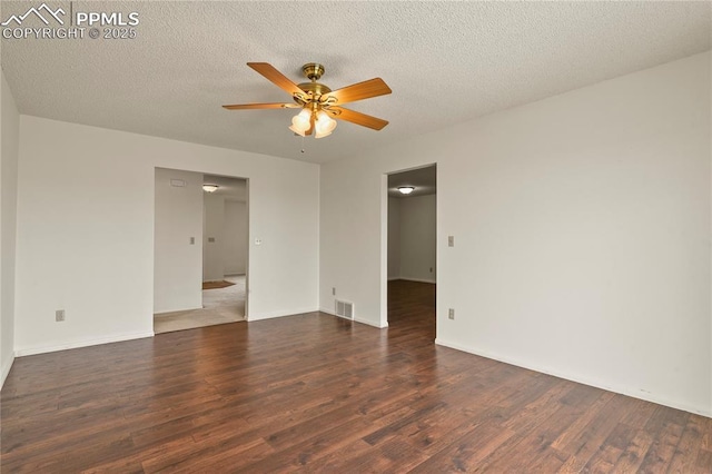 spare room with dark hardwood / wood-style floors, a textured ceiling, and ceiling fan