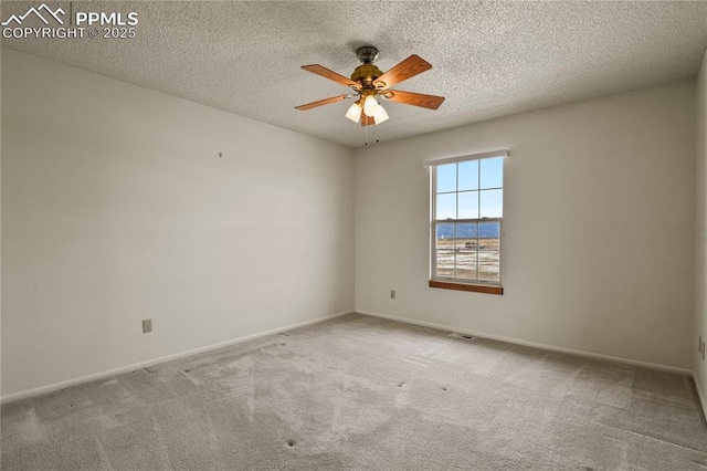 empty room featuring a textured ceiling, ceiling fan, and carpet