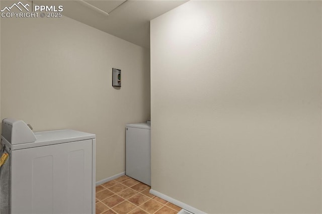 laundry area featuring light tile patterned flooring and washer and clothes dryer
