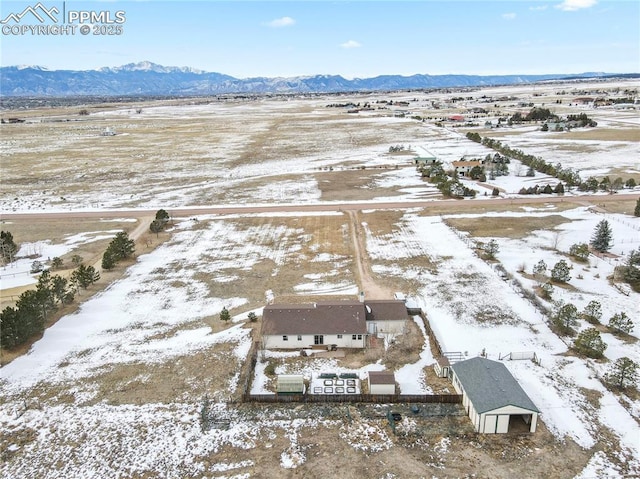 snowy aerial view with a mountain view