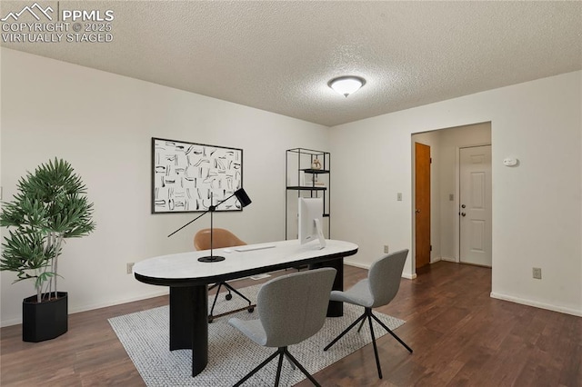 office area with dark hardwood / wood-style flooring and a textured ceiling