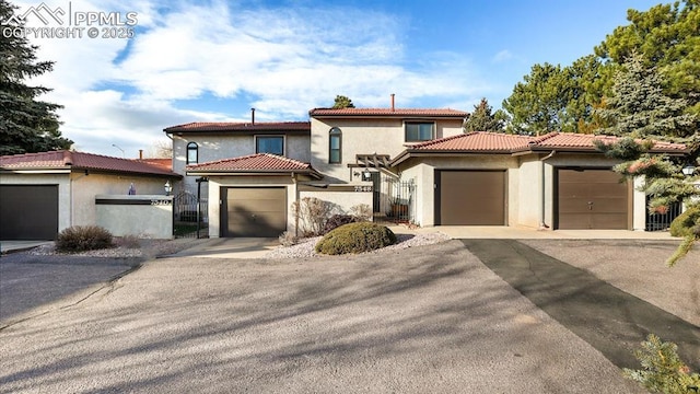 mediterranean / spanish home with a garage