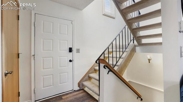 stairway featuring wood-type flooring