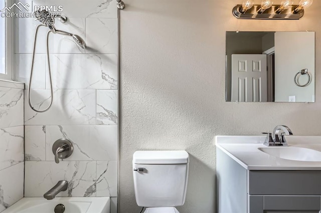 full bathroom featuring vanity, toilet, and tiled shower / bath