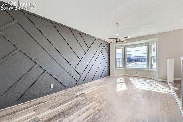 interior space featuring a notable chandelier and light hardwood / wood-style flooring