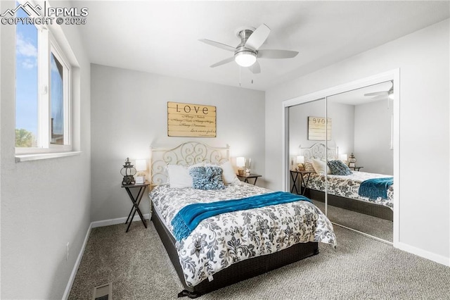 carpeted bedroom with ceiling fan and a closet