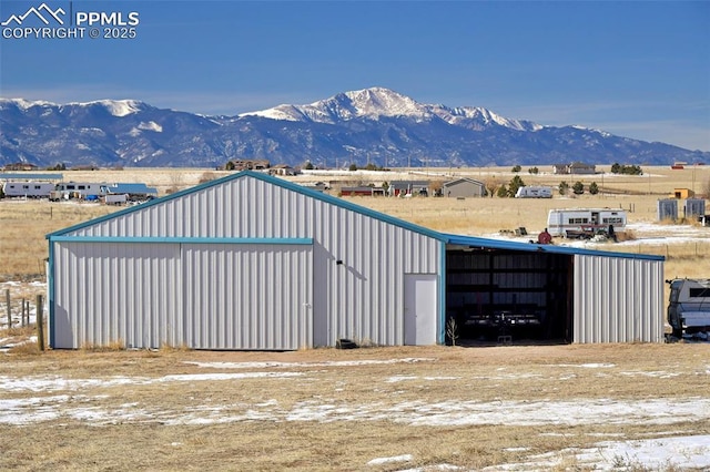 exterior space featuring a mountain view and an outbuilding