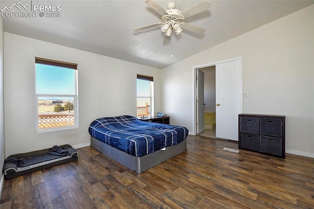 bedroom with dark wood-type flooring, ceiling fan, and vaulted ceiling