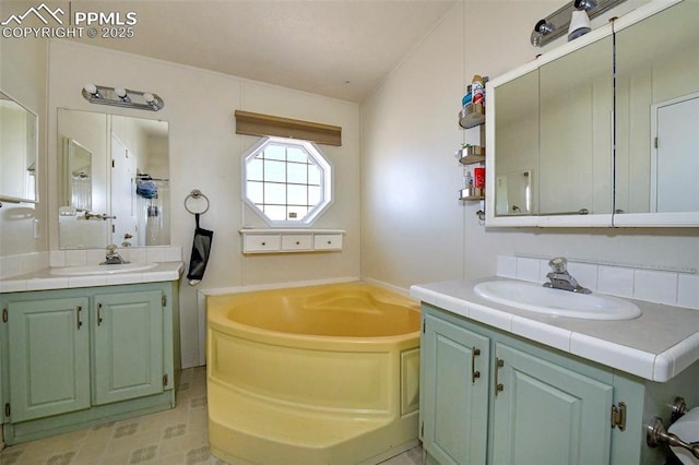 bathroom with vanity and a bathtub