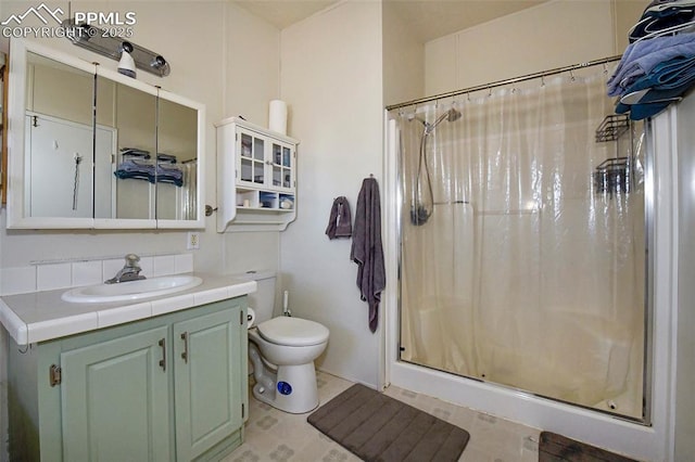 bathroom with a shower with shower curtain, vanity, decorative backsplash, tile patterned floors, and toilet