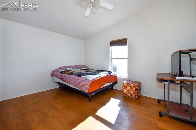 bedroom with hardwood / wood-style flooring, vaulted ceiling, and ceiling fan