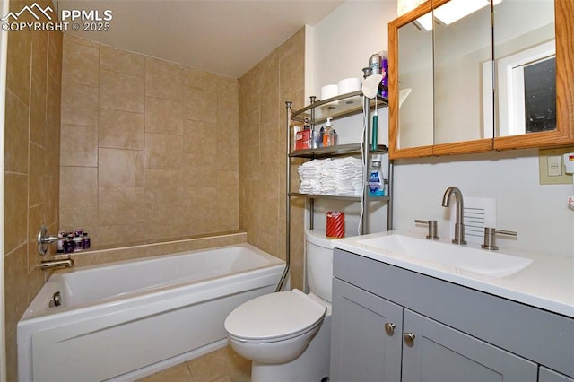 full bathroom featuring tile patterned flooring, vanity, tiled shower / bath, and toilet