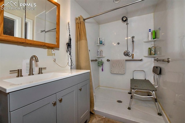 bathroom with vanity, tile patterned flooring, and walk in shower