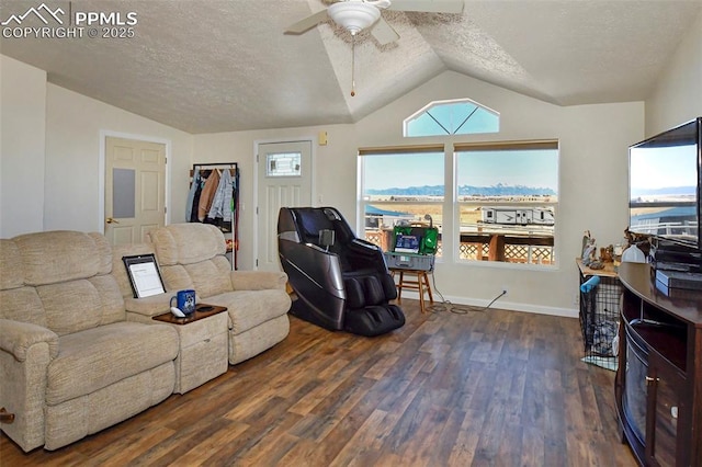 living room with dark wood-type flooring, a textured ceiling, and a wealth of natural light