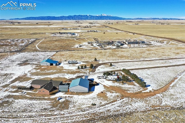 snowy aerial view with a mountain view