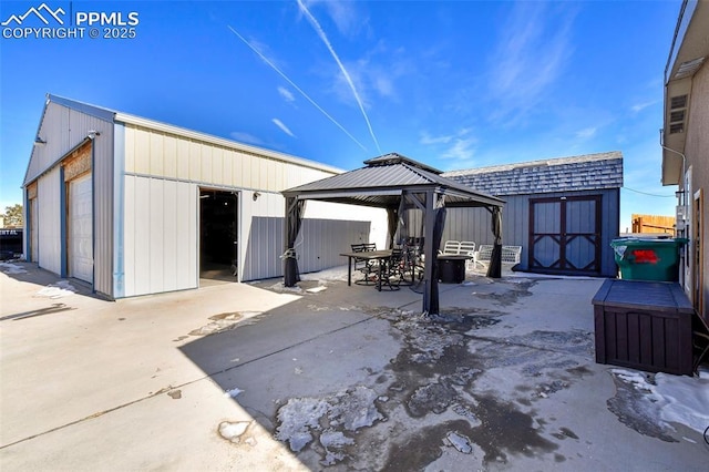 view of patio featuring an outbuilding and a gazebo