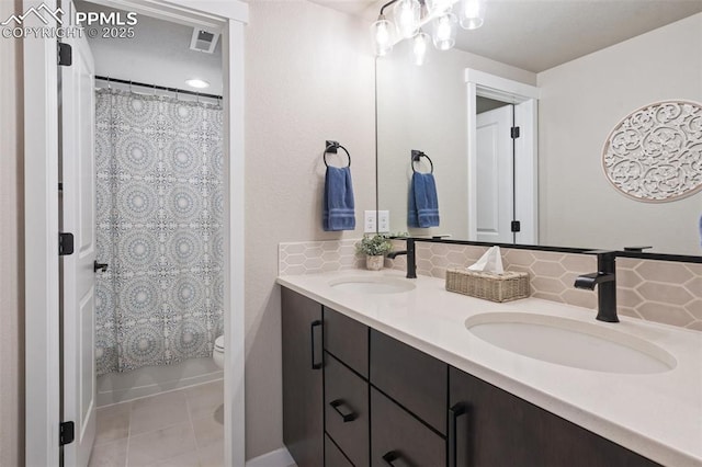 full bathroom featuring shower / tub combo with curtain, tile patterned floors, toilet, vanity, and decorative backsplash