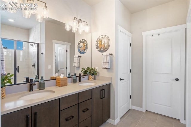 bathroom with tile patterned flooring, vanity, and a shower with shower door