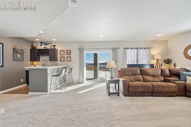 living room with light colored carpet and bar