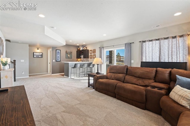 carpeted living room with bar