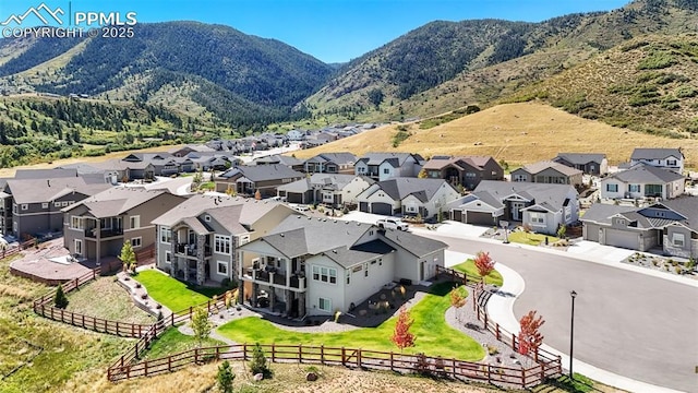 birds eye view of property with a mountain view