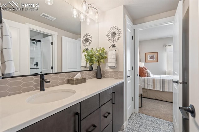 bathroom featuring tasteful backsplash, vanity, and tile patterned flooring