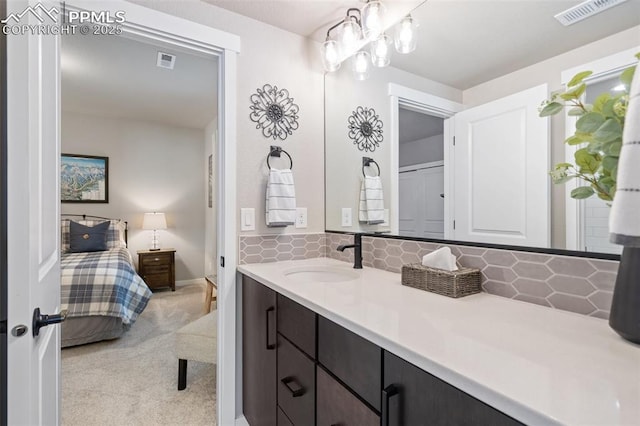 bathroom with tasteful backsplash and vanity