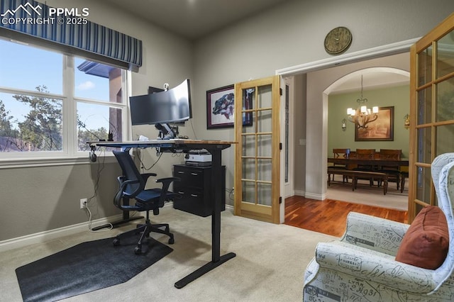 office space featuring french doors, carpet, and an inviting chandelier