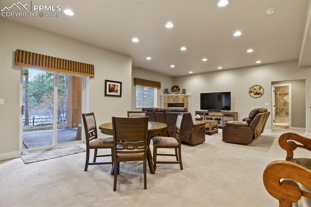 carpeted dining area featuring a tile fireplace