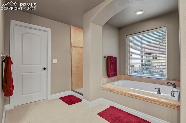 bathroom with shower with separate bathtub