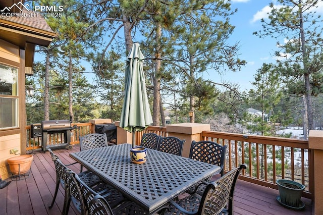 wooden terrace featuring a grill