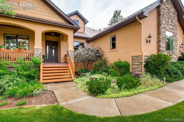 view of exterior entry featuring covered porch