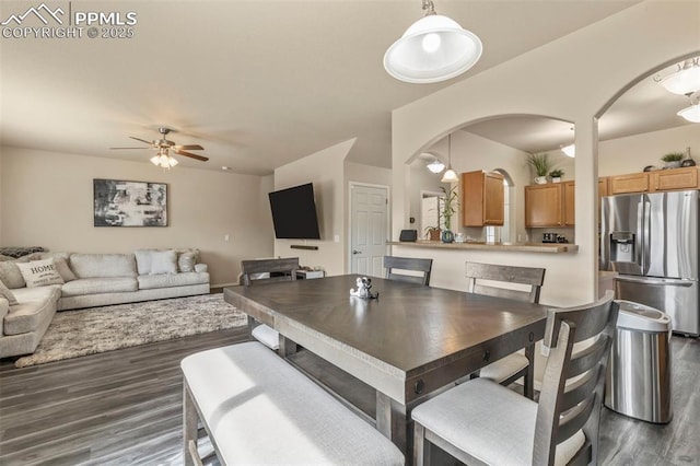 dining space featuring ceiling fan and dark hardwood / wood-style flooring