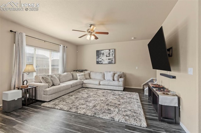 living room featuring ceiling fan and dark hardwood / wood-style flooring