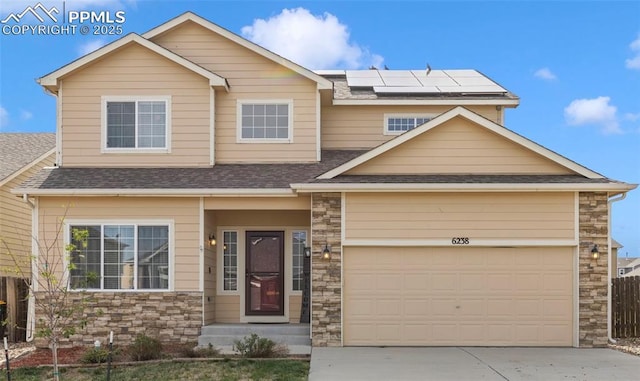 craftsman-style house with a garage and solar panels