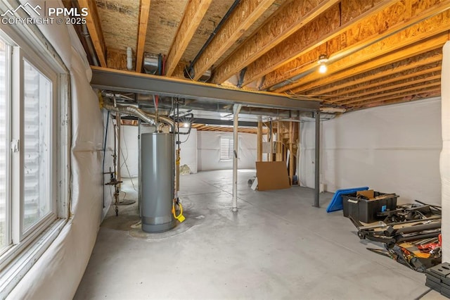 basement with gas water heater and a healthy amount of sunlight