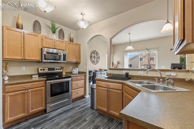 kitchen with sink, decorative light fixtures, dark hardwood / wood-style floors, and appliances with stainless steel finishes