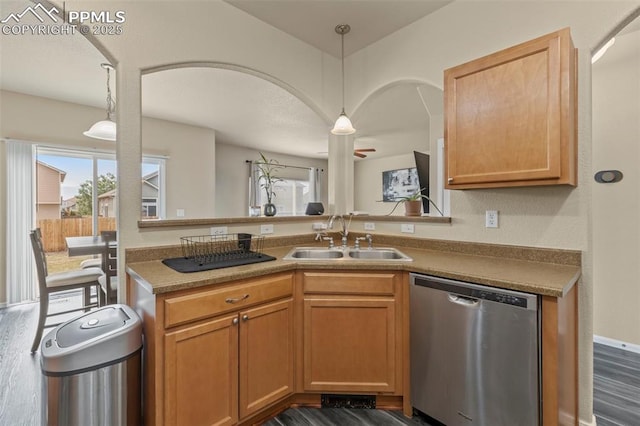 kitchen featuring sink, decorative light fixtures, dark wood-type flooring, and stainless steel dishwasher