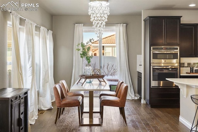 dining room with a notable chandelier and dark hardwood / wood-style flooring