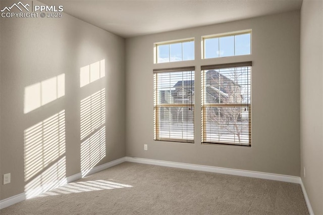 carpeted empty room with a high ceiling