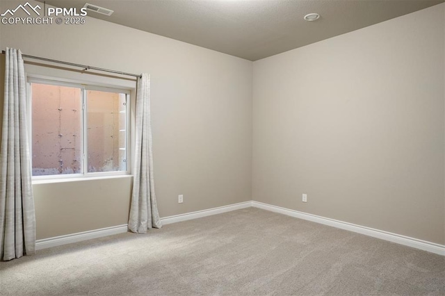 empty room featuring light carpet