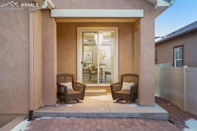 view of exterior entry with a patio