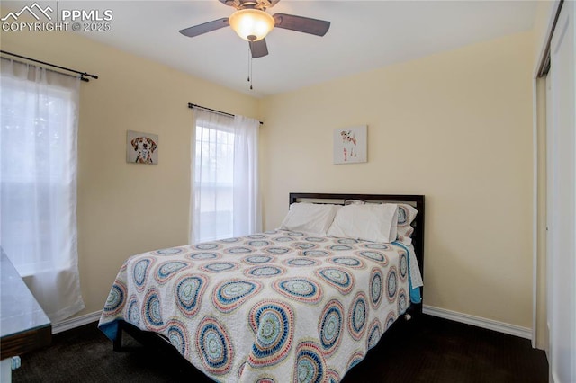 bedroom with a ceiling fan and baseboards