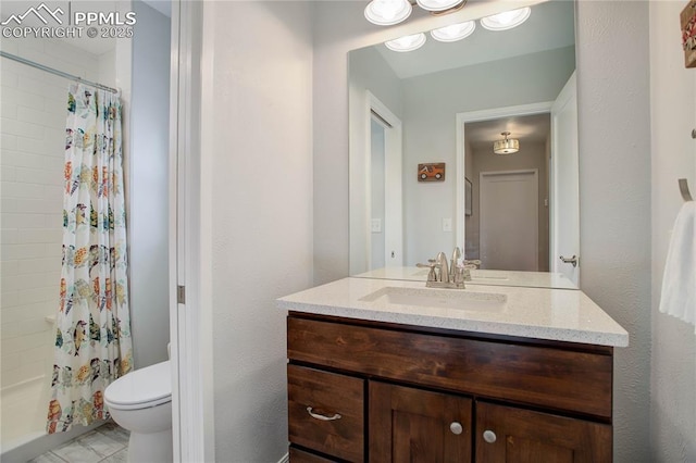 bathroom featuring toilet, vanity, and a shower with curtain