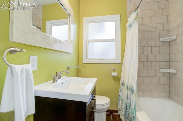 bathroom featuring vanity, toilet, and shower / tub combo with curtain