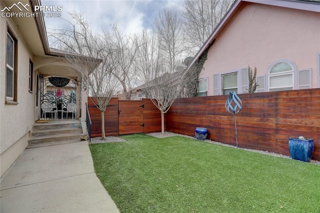 view of yard featuring a gate and a fenced backyard