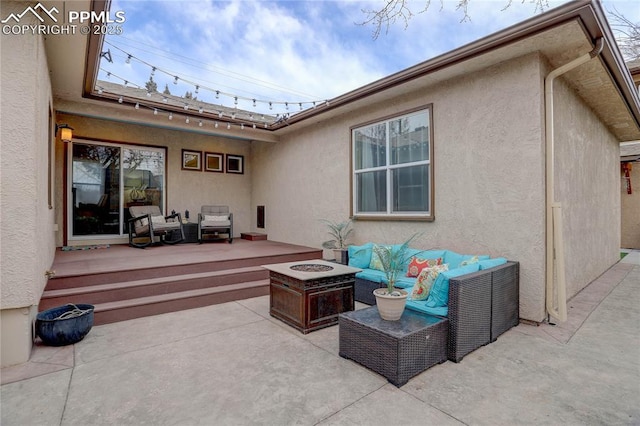 view of patio featuring an outdoor living space with a fire pit