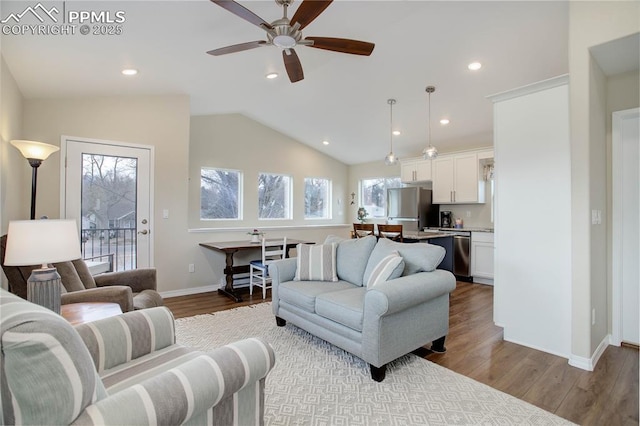 living room with lofted ceiling, baseboards, wood finished floors, and recessed lighting